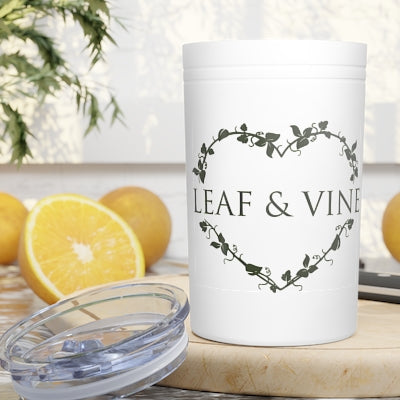 White Leaf & Vine Mug or container with a heart-shaped vine design, placed on a table with a sliced orange and whole oranges in the background